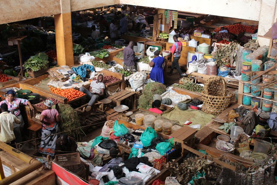 Vendors at Kalaw's central market selling produce and spices under a corrugated roof