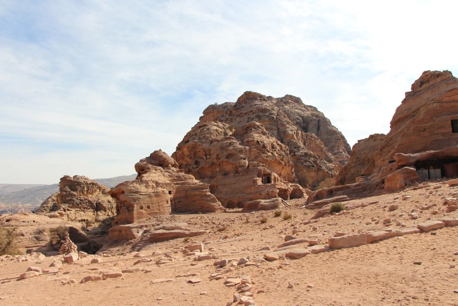 Una vista desde el yacimiento de excavación de Beidha mirando hacia las colinas de arenisca que llevan a la Pequeña Petra, el fondo del wadi abajo salpicado de vegetación arbustiva