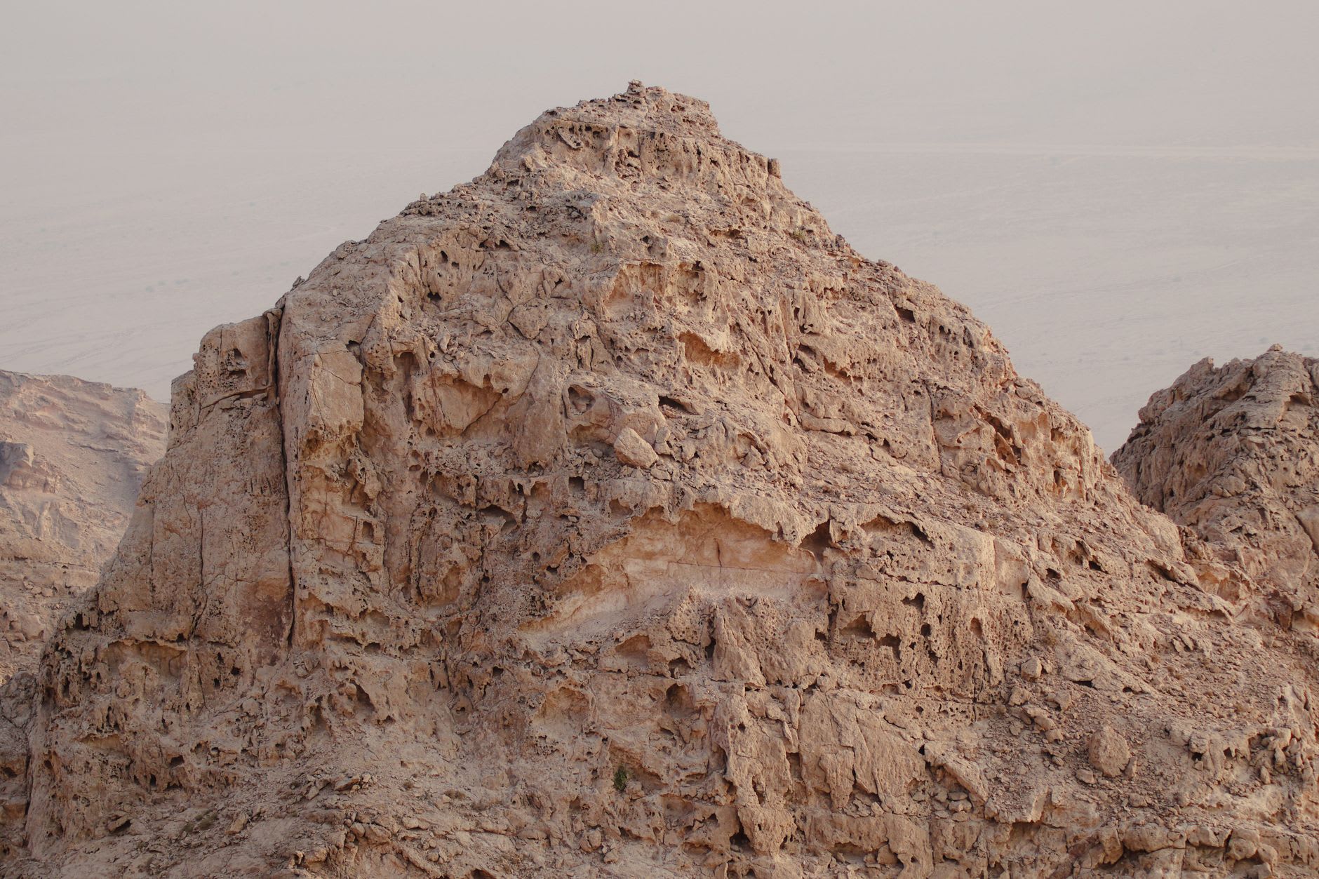 Panoramic view from Jabal Haroun's summit looking back toward the mountains of Petra, the colonnaded valley visible far below