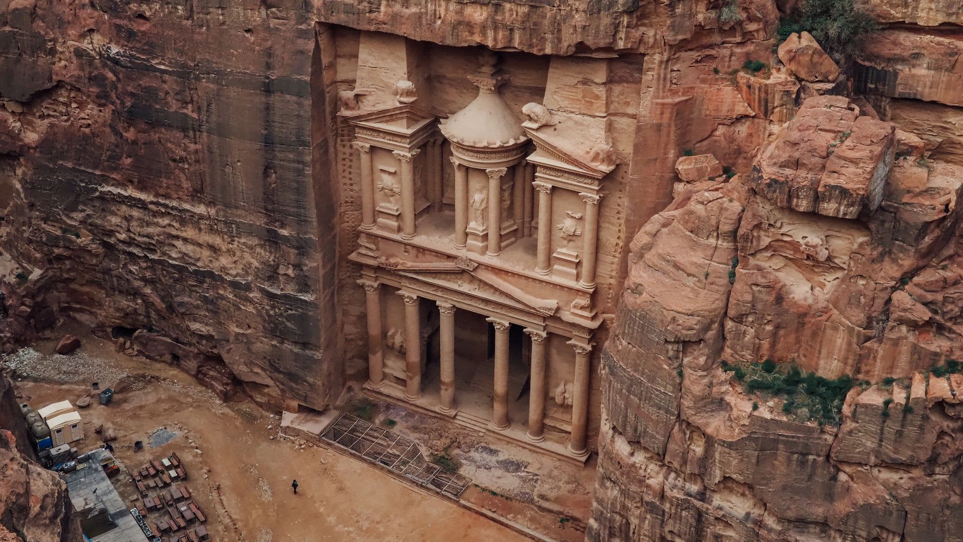 The narrow walls of the Siq closing in as the first light touches the upper sandstone