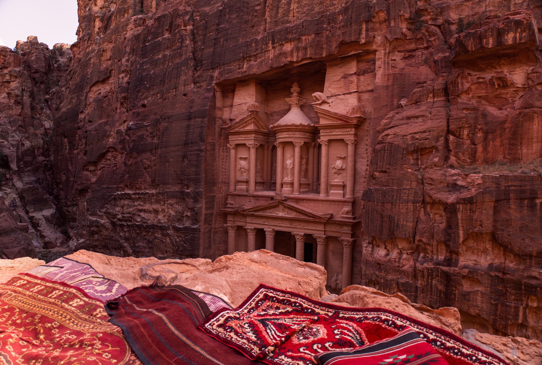 Al-Khazneh Treasury facade glowing in the first horizontal light of morning, pink and gold