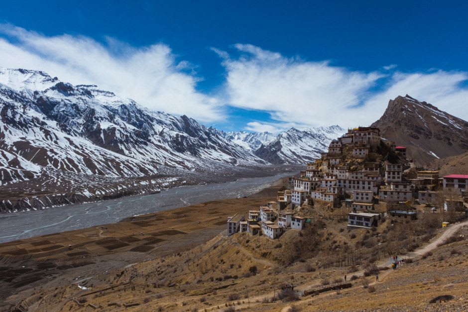 View down the eroded ochre canyon from the mouth of Luri Gompa cave, with Yara village visible far below