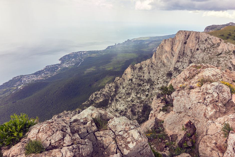 La vue depuis la crête sommitale du Mont Panié pendant une brève éclaircie dans les nuages, montagnes et littoral visibles en contrebas