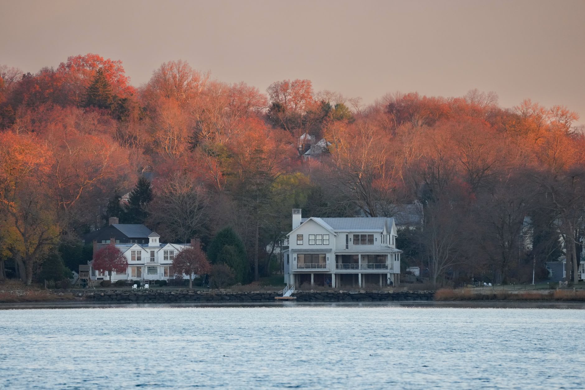 The village of Mystic reflected in the calm Mystic River on an early morning, the drawbridge and white clapboard buildings in the background