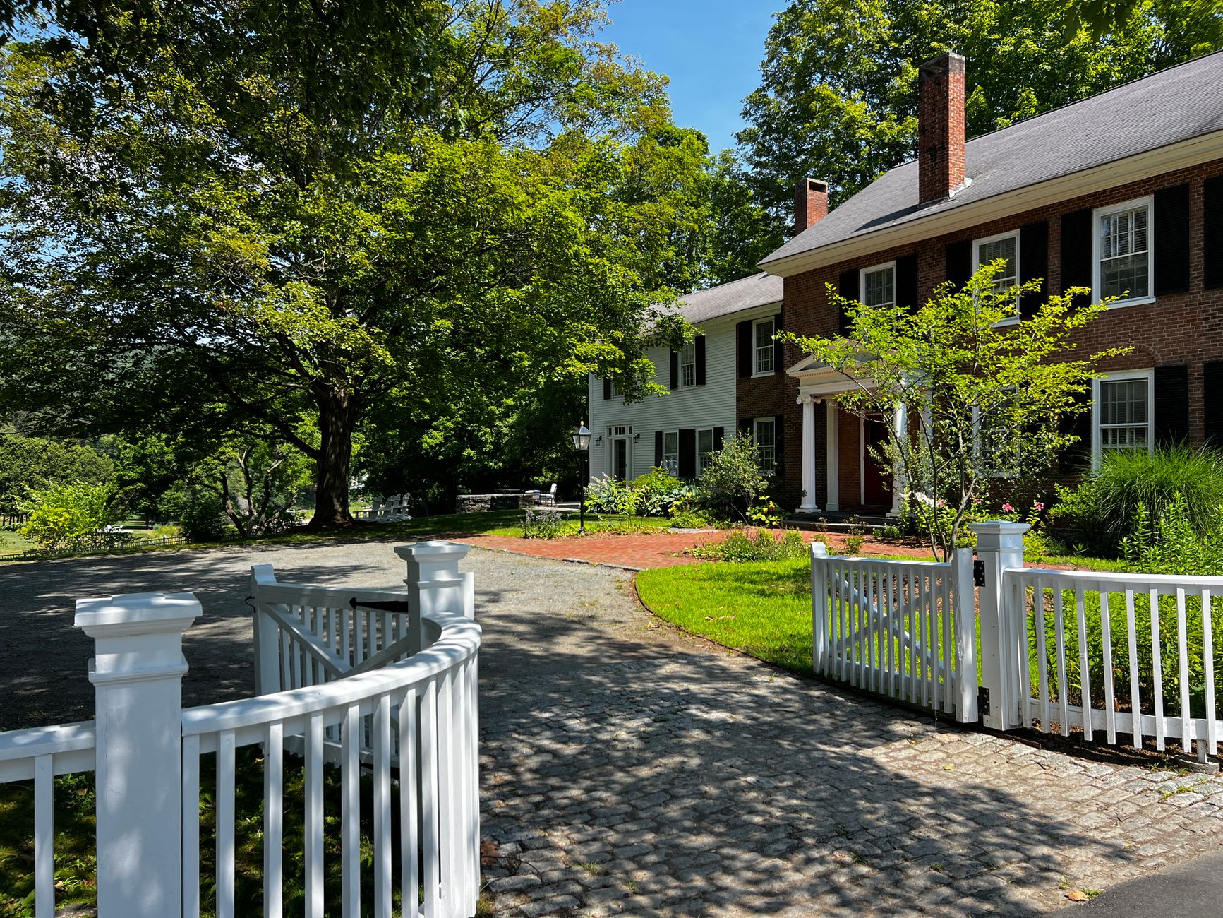 The Billings Farm at Woodstock, its red barns and white fences set against a hillside of blazing October maple color