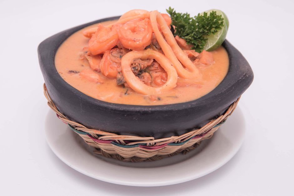 A bowl of rondón coconut seafood stew served in a Bluefields kitchen