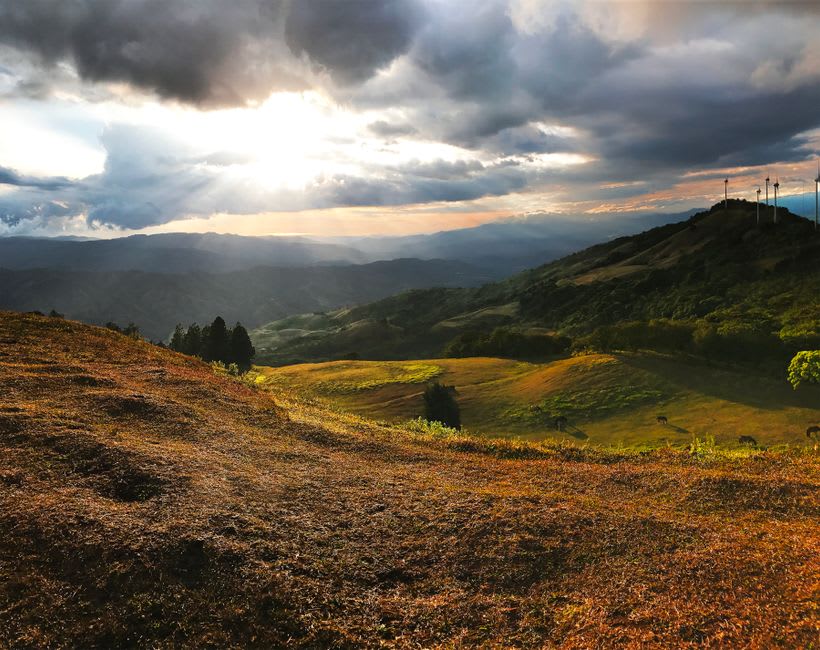 Rolling green cattle hills seen from the upper level of Boaco at sunset