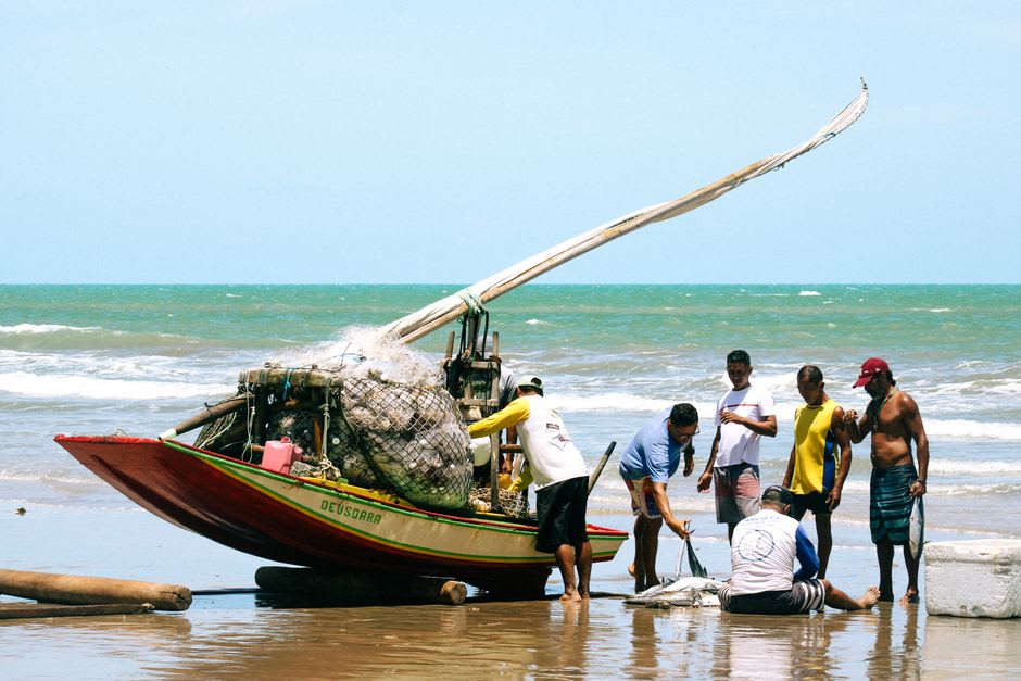 Fishermen unloading their catch onto the beach at Casares early in the morning