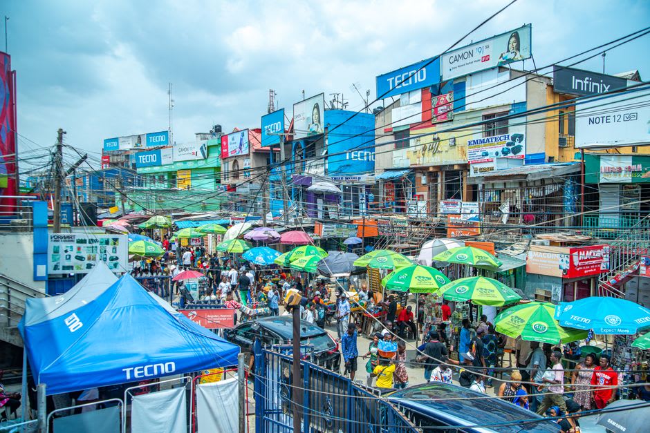 Busy market street in central Rivas with vendors and colonial buildings