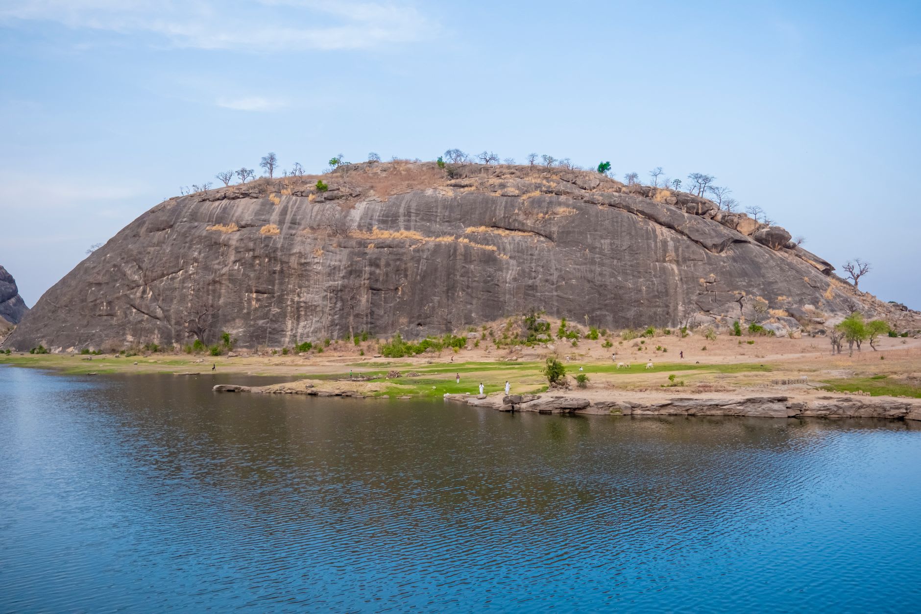 The view from the summit of Olumo Rock over Abeokuta's red rooftops, granite outcrops, and the dome of the central mosque