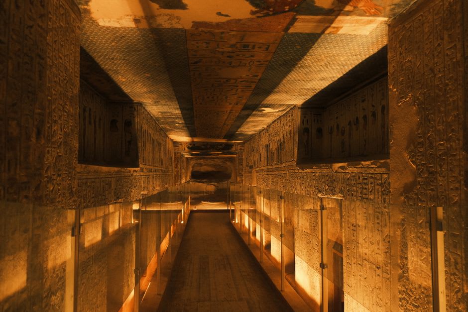 A narrow tomb corridor descending into the rock in the Valley of the Queens