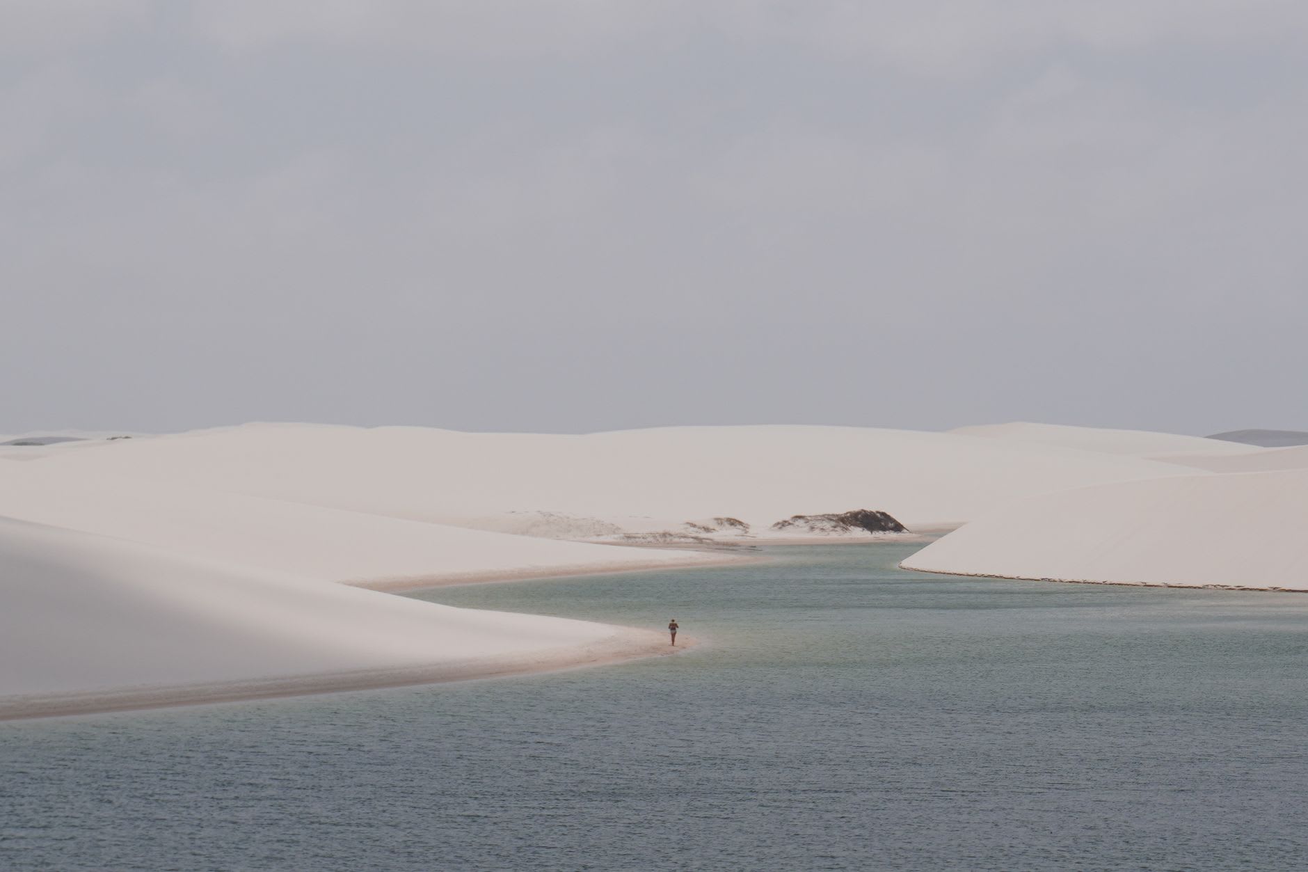 Swimming in Lagoa Azul — a still turquoise pool between white dune ridges, utterly empty, the only sound a light wind moving over the sand