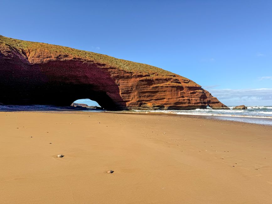 The red sandstone sea caves at Cushendun carved by centuries of tide