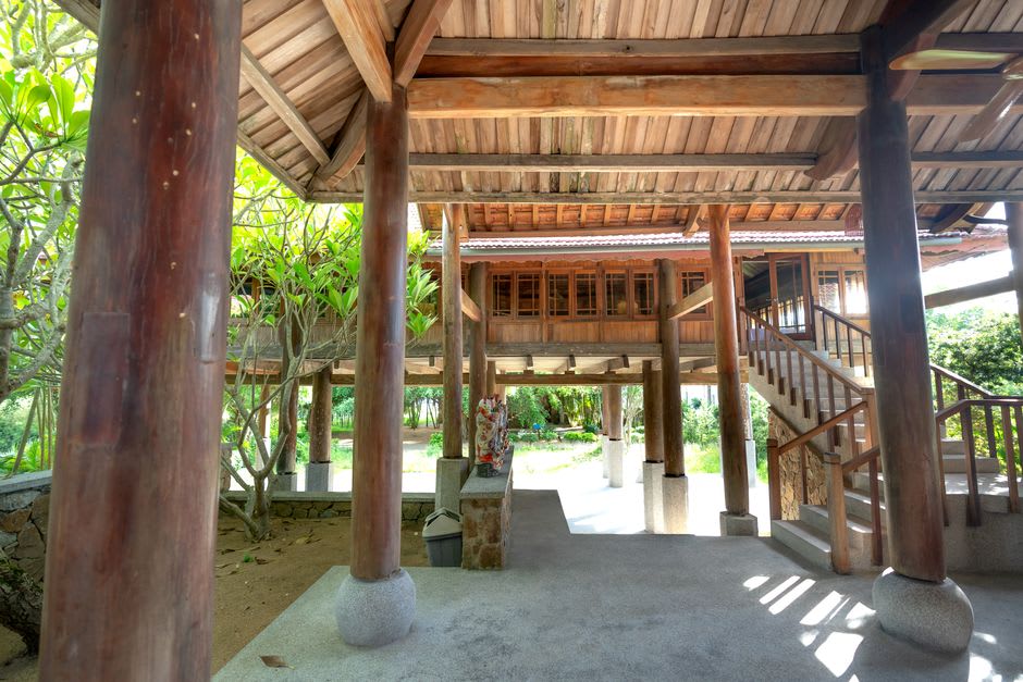 Carved teak pillars and shuttered windows of Vongburi House in Phrae