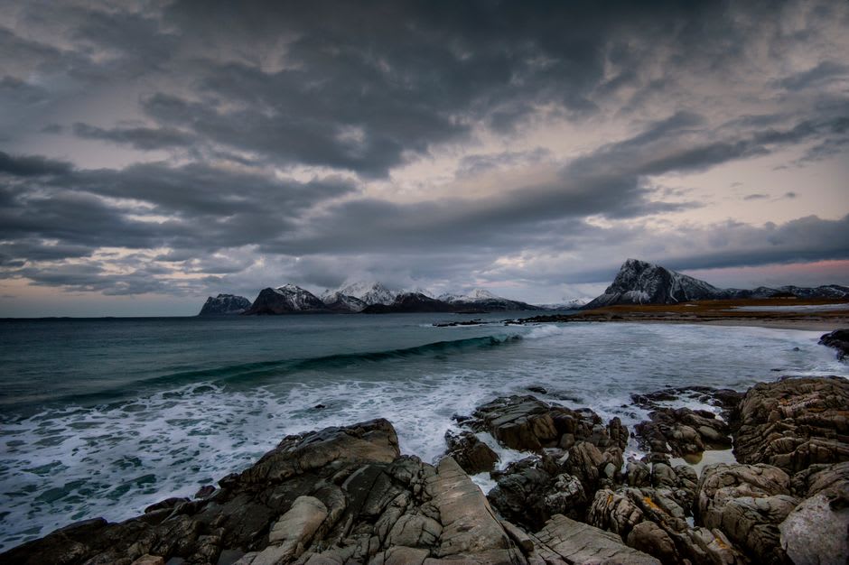 The rocky shoreline and coastal cliffs of Runde with waves breaking below