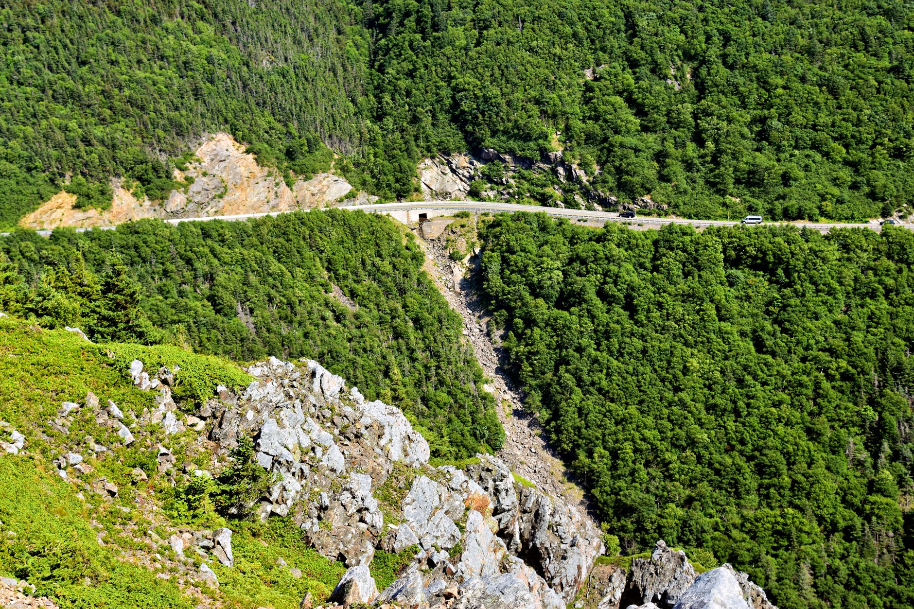 Cabot Trail road curving along dramatic sea cliffs dropping to the Gulf of St. Lawrence below