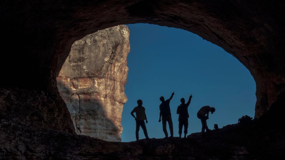 Underground lake reflecting stalactites deep inside Al Hoota Cave