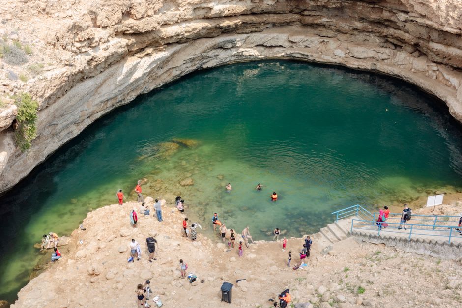 Stone steps descending into the turquoise Bimmah Sinkhole crater, Oman