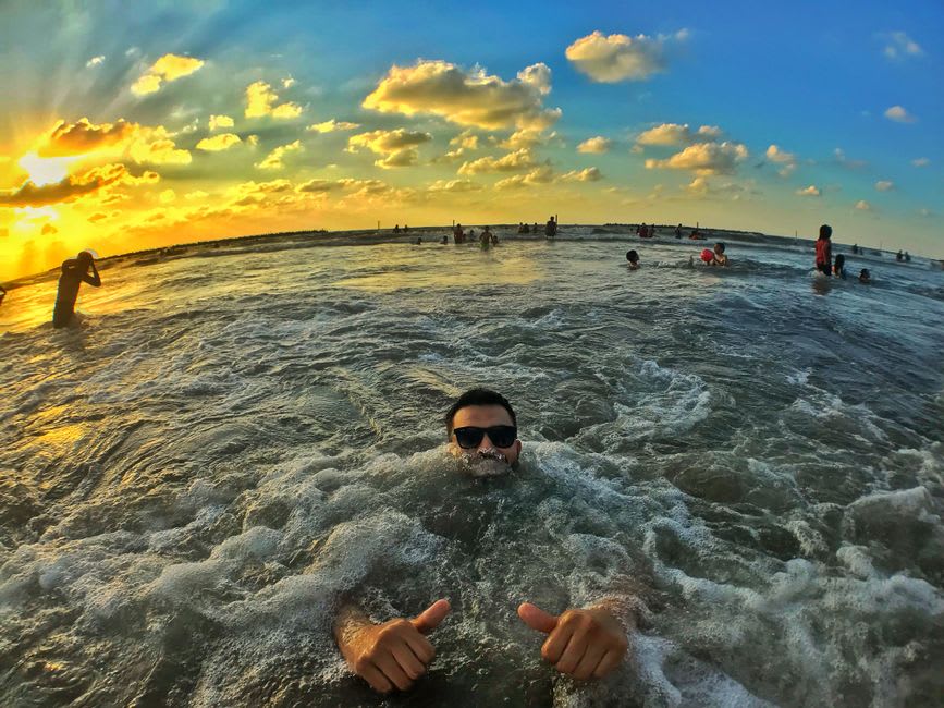 Acantilados verticales de Ras Madrakah cayendo directo al mar, vistos desde un campamento en lo alto al atardecer