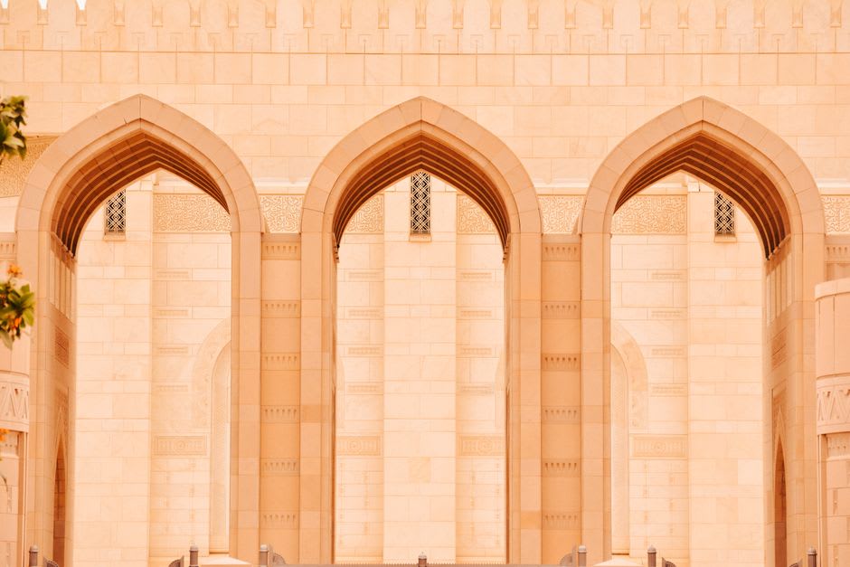 Geometric marble courtyard and reflecting pool at Sultan Qaboos Grand Mosque