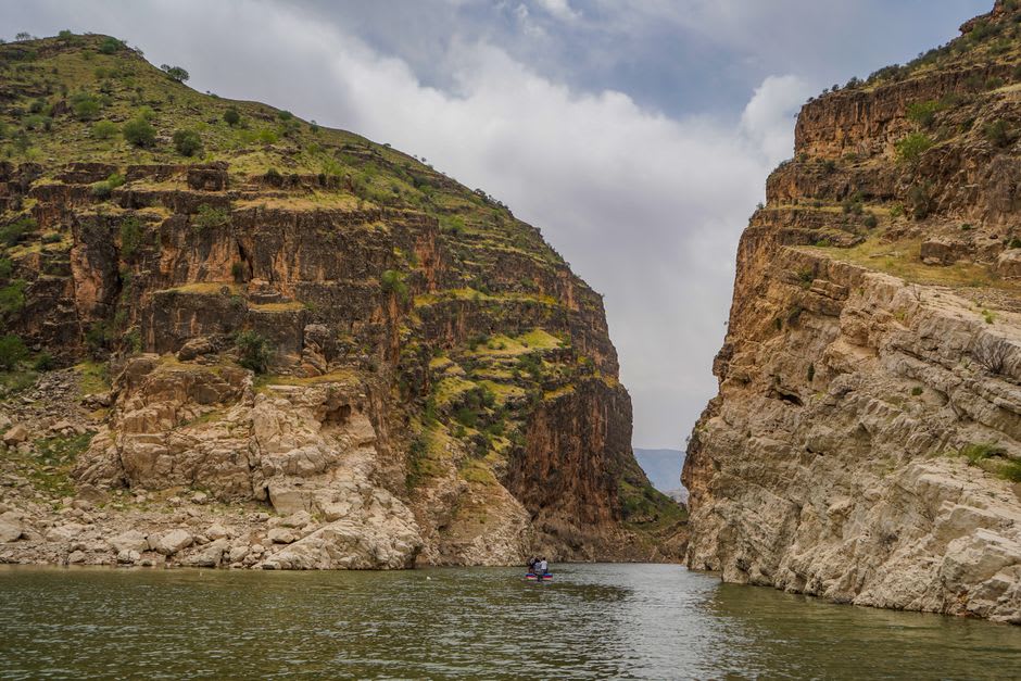 A jet boat cutting through the Snake River at the base of Hells Canyon