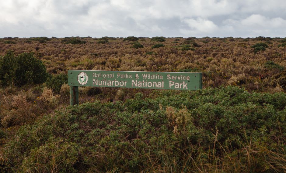 A hand-painted roadhouse sign warning of camels, wombats, and kangaroos on the Nullarbor's Eyre Highway