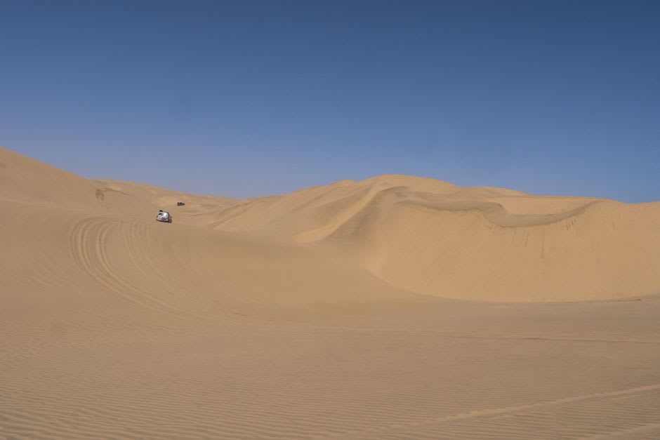 The steep red face of Big Red dune near Birdsville with a vehicle track cut into the sand