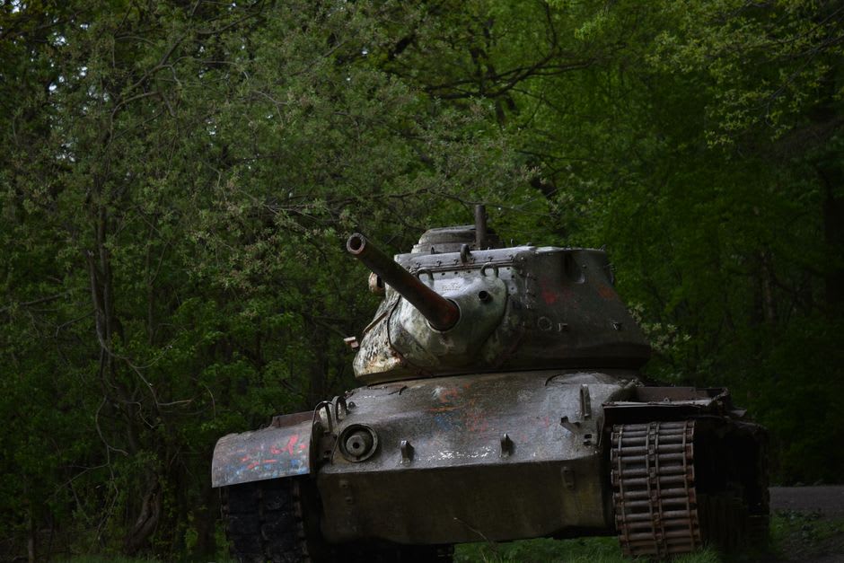 A rusting Japanese tank half-swallowed by jungle vines on Angaur Island