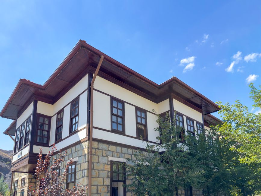 Restored Ottoman-era stone mansion in Birzeit's old town with carved doorway and cross-vaulted ceiling visible inside