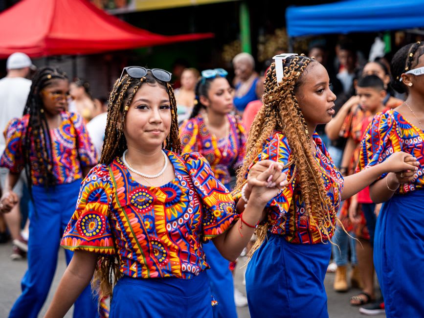 Colorfully painted Congo dancers in traditional costume performing in the streets of Portobelo during a festival
