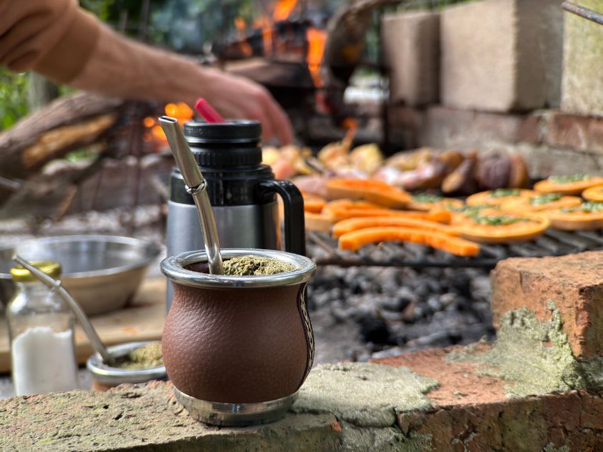 A vendor's stall in the Paraguari market piled with fresh yerba mate and produce
