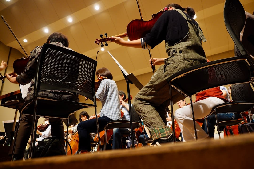 A youth orchestra rehearsing strings inside a music school in Villarrica, afternoon light coming through open windows