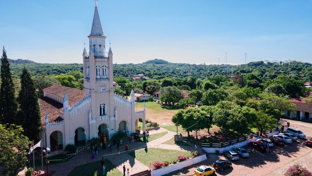 The whitewashed plaza and freestanding colonial bell tower of Yaguaron under bright midday light