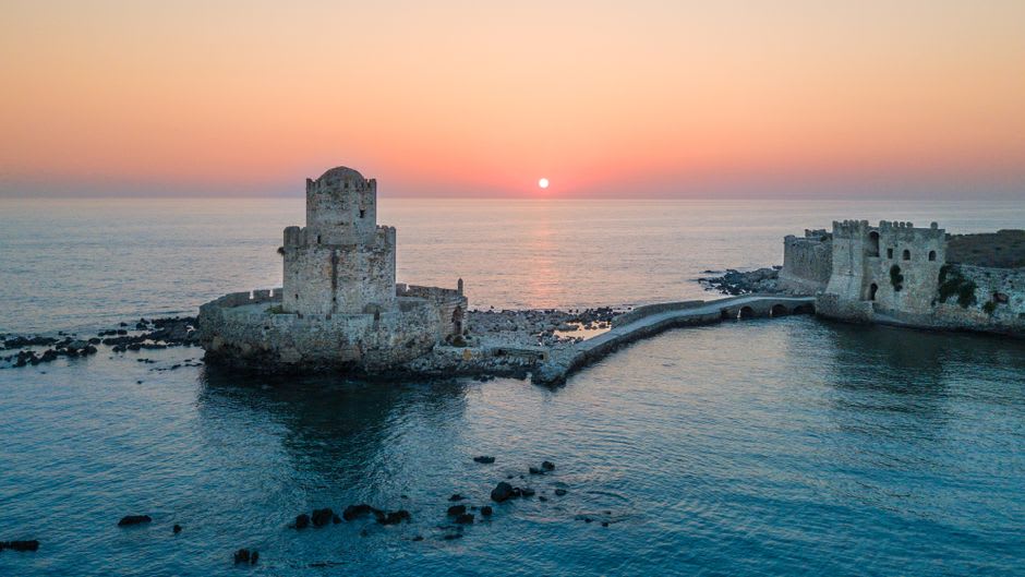 Weathered stone walls and archway inside Methoni Castle, Peloponnese