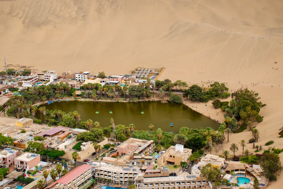 Golden desert dunes stretching into the distance under a vast blue sky