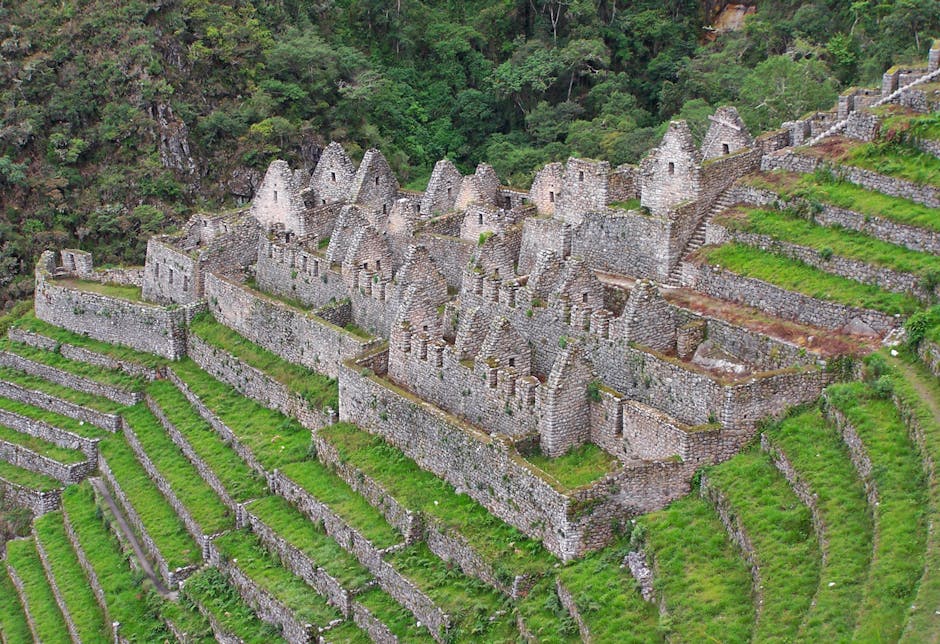 Stone terraces and ancient walls of Machu Picchu with dramatic mountain backdrop