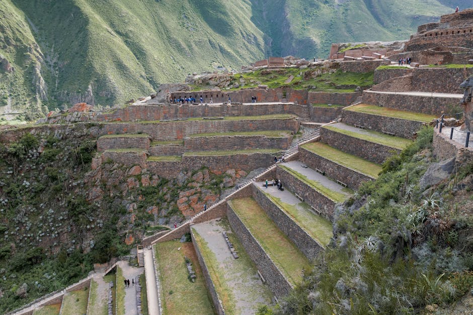 Inca ruins and terraces overlooking the green Sacred Valley and Urubamba River