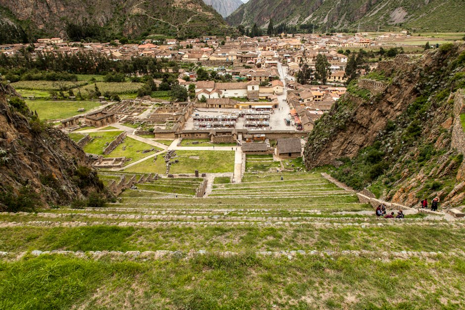 Ancient circular terraced agricultural site surrounded by green Andean hills