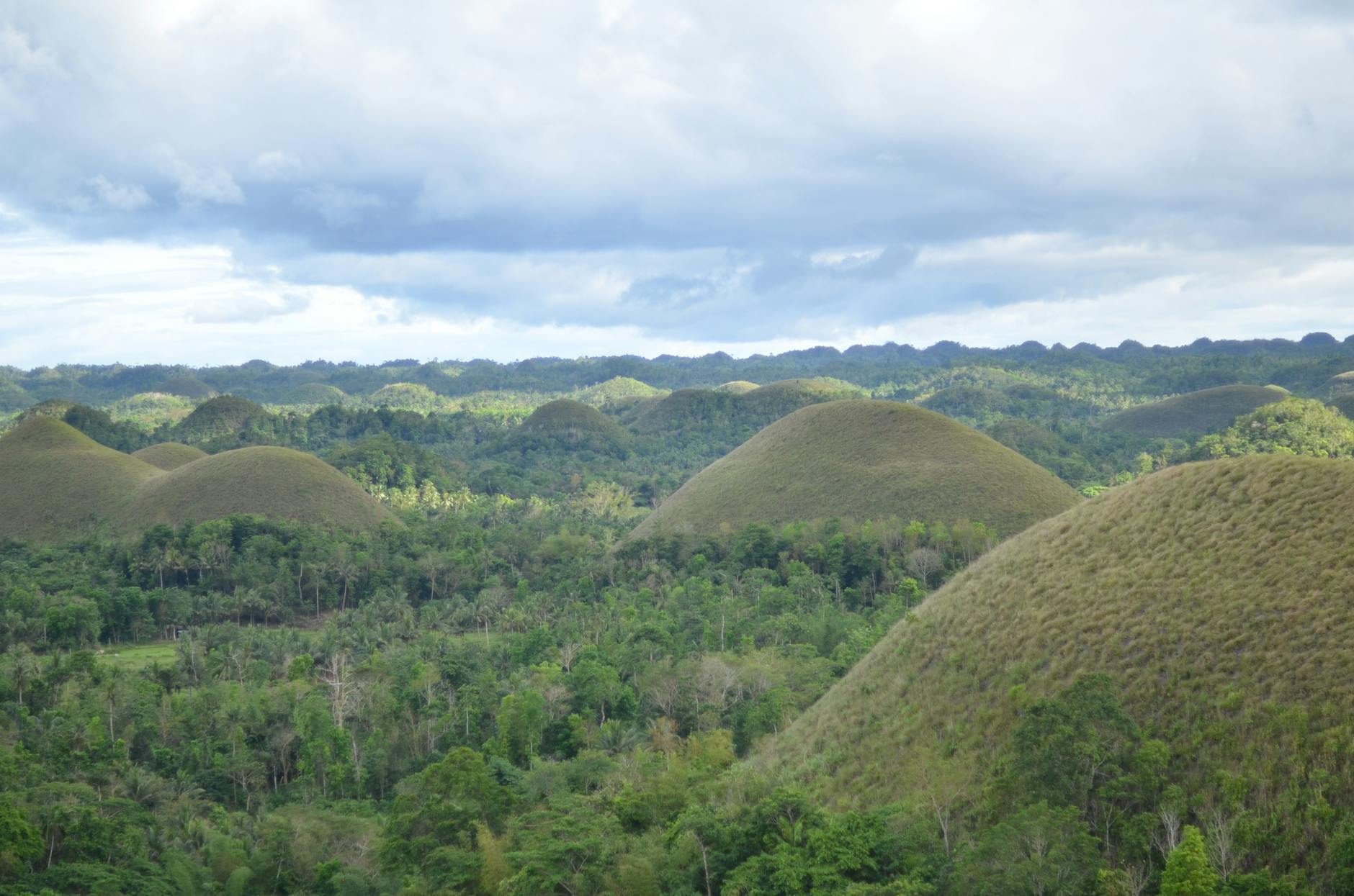 Rolling green Chocolate Hills under dramatic clouds in Bohol