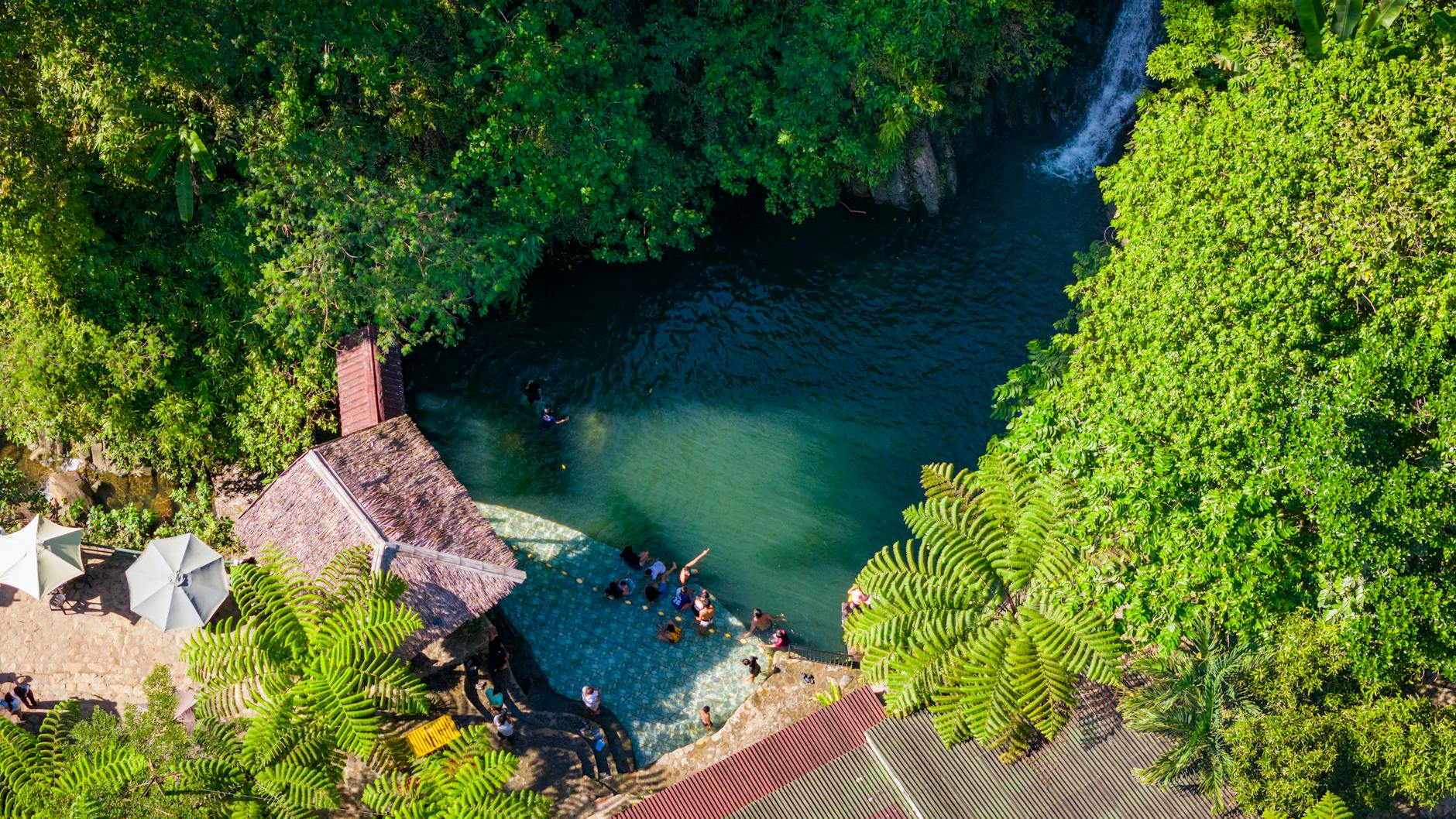 Turquoise waterfalls cascading through lush tropical jungle in Cebu