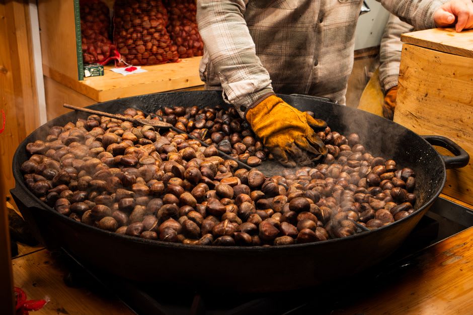 Agricultural fair stalls selling chestnuts and local produce in Alijó's town square during Feira dos Santos