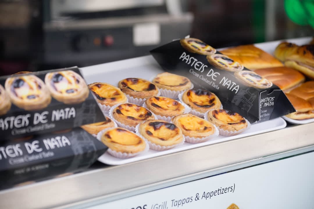 Traditional São Gonçalo pastries and cakes displayed in a bakery window in Amarante