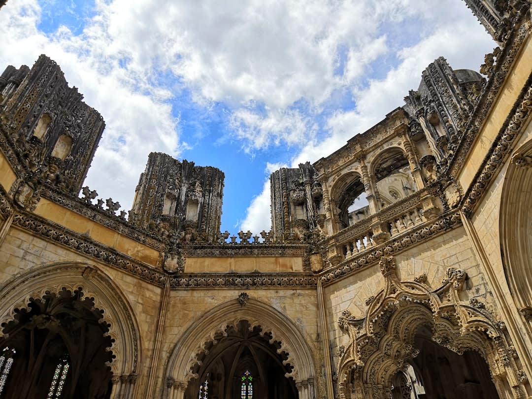 The roofless Gothic ruins of the Paço dos Condes palace with medieval stone tombs open to the sky