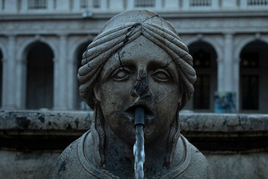 Renaissance marble fountain in a small square in Castelo de Vide at dusk