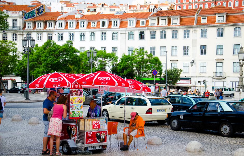 Saturday market stalls filling the Rossio square in Estremoz with cheese, produce, and pottery
