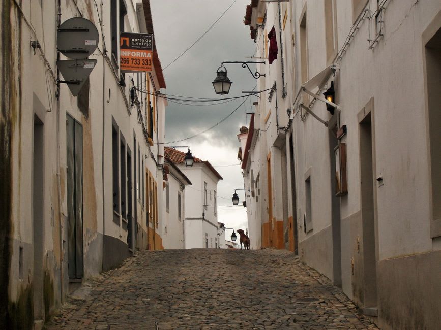 Narrow granite street in Guarda's old Jewish quarter with weathered stone doorways