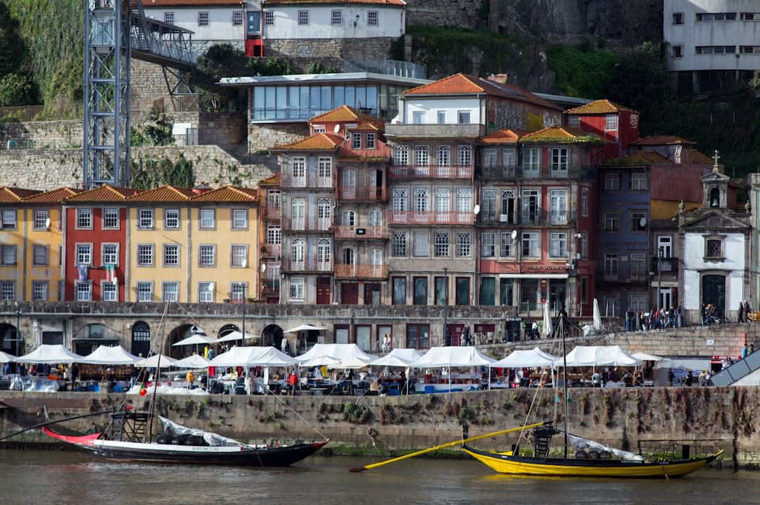 Traditional flat-bottomed rabelo boats moored along the riverfront promenade in Peso da Régua