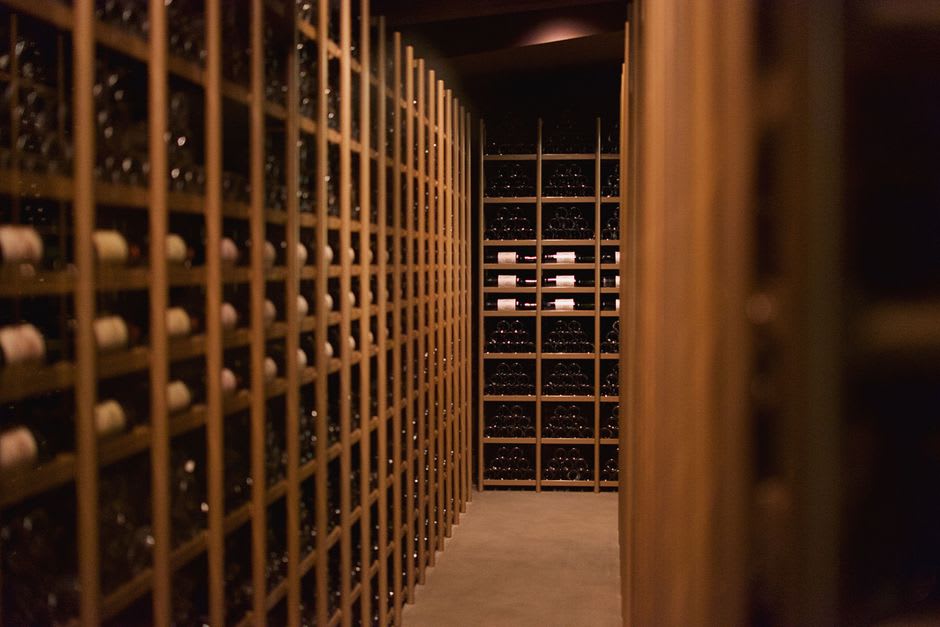 Whitewashed adega wine cellar building surrounded by black lava rock vineyard walls on Pico Island