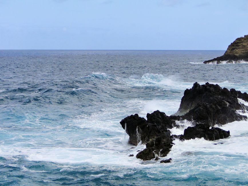 Waves crashing against dark volcanic rock stacks just offshore from the Ponta de São Lourenço peninsula