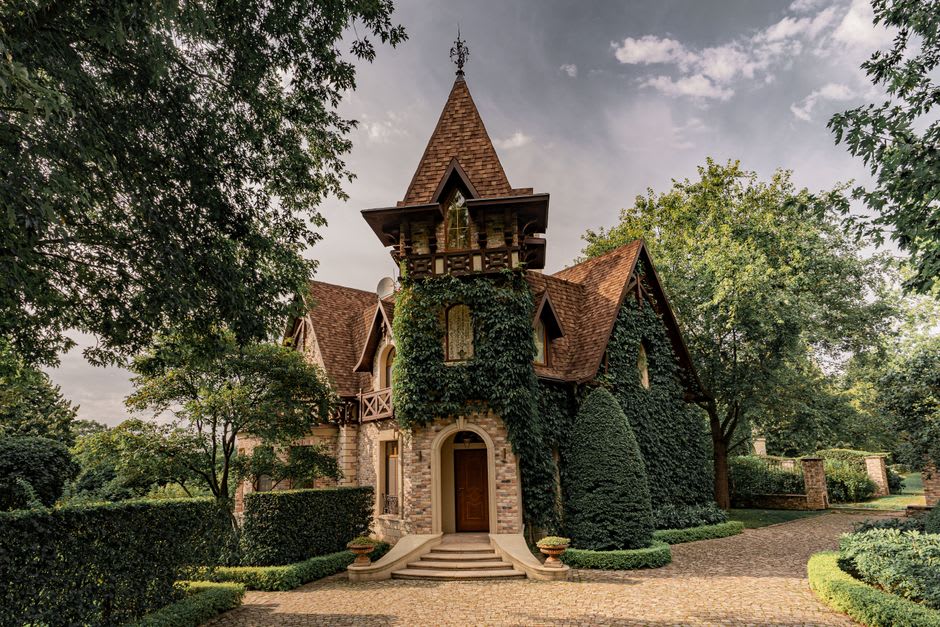 Stone manor house with a vine-covered granite trellis and carved family coat of arms in Ponte de Lima